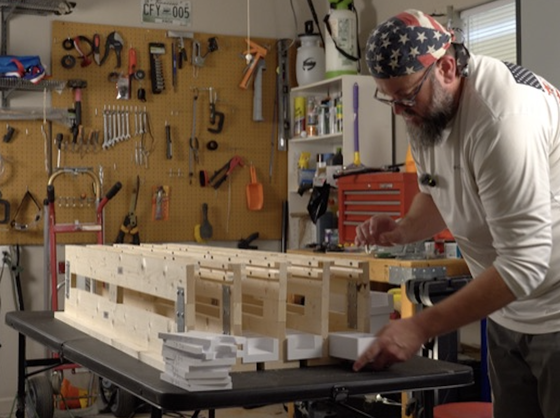 Fitting a 3D-printed spacer into the long rack frame during assembly